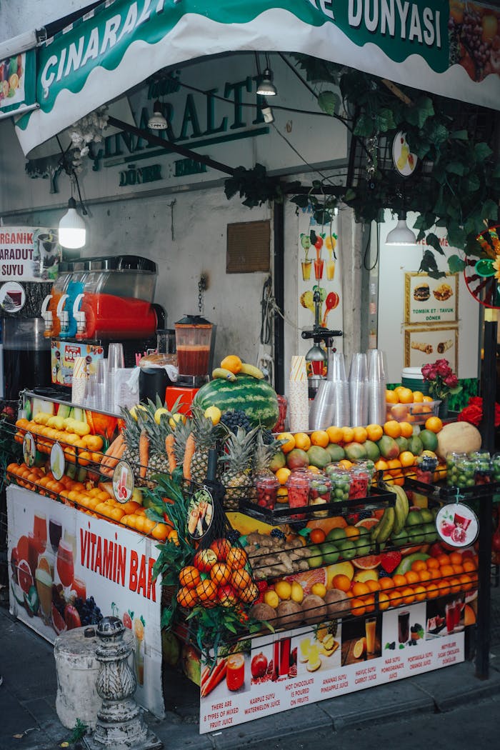 Colorful outdoor juice bar with fresh fruits and vibrant produce display.